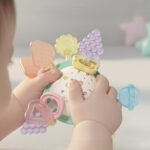Krystal Silicone Sensory Teether Ball Krystal silicone baby sensory teether ball with colorful Manhattan-style grasp arms for teething relief