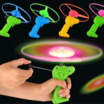 Krystal LED spinning UFO flying toy with pull string launcher and glowing light-up disk for kids outdoor play