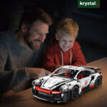 1:14 scale white Porsche 911 inspired building block supercar model being enjoyed by a father and son
